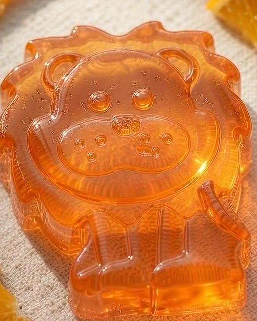 Leo the Lion — a translucent orange kids soap — as a little goldfish swims past